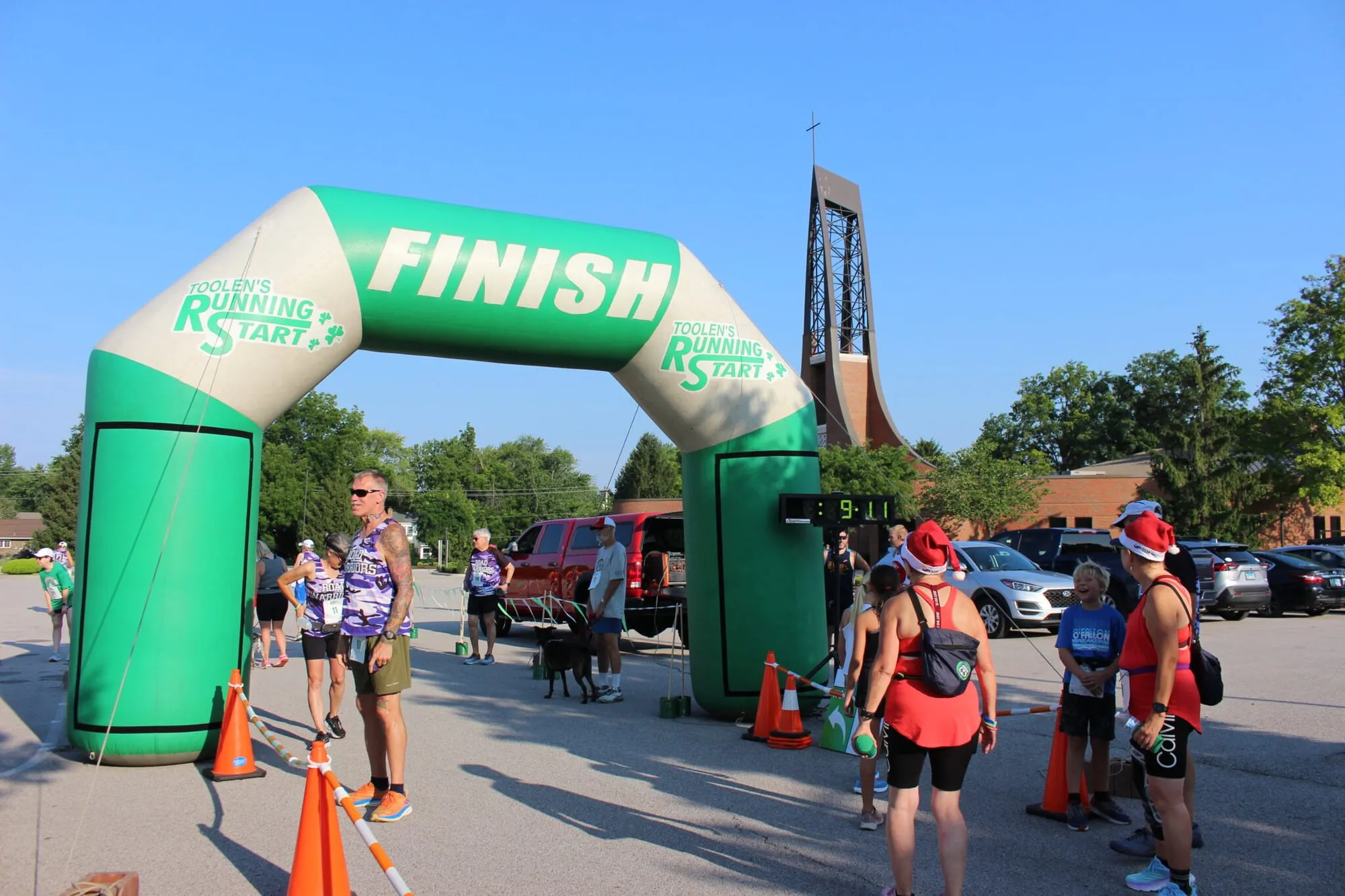 Runners approaching the inflatable finish arch with spectators lining the road.
