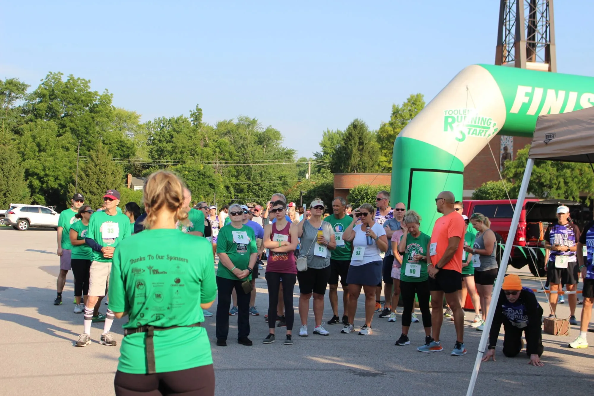 A crowd of walkers making their way through the finish arch together.