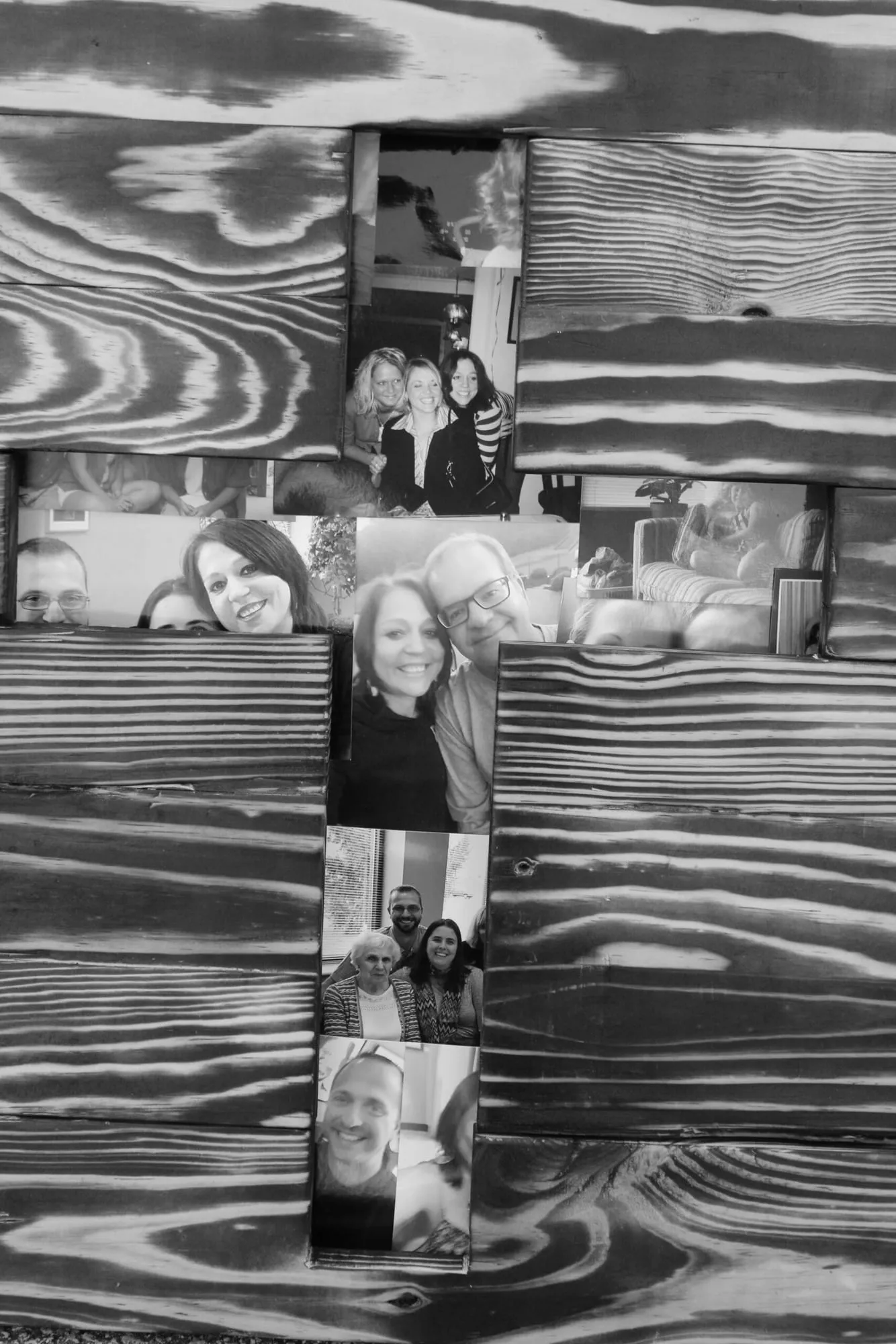 A black and white display of framed family photographs of Jennifer Mueller.
